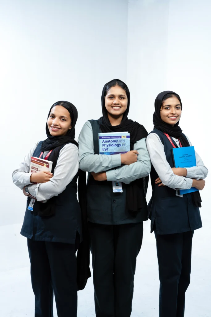 Three ophthalmology students standing together with academic textbooks, representing teamwork, education, and future eye care professionals